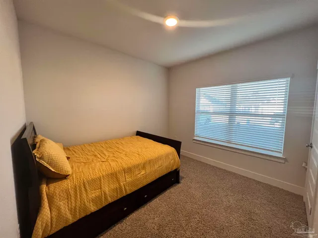 a bedroom with a bed and cabinet