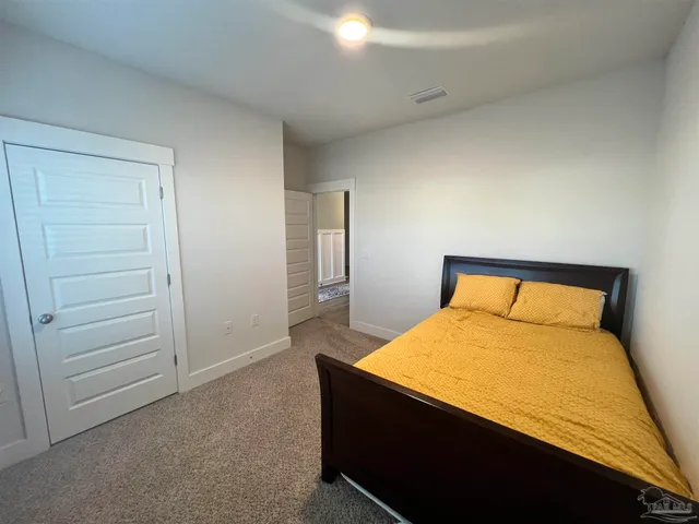 a bedroom with a bed and a couch