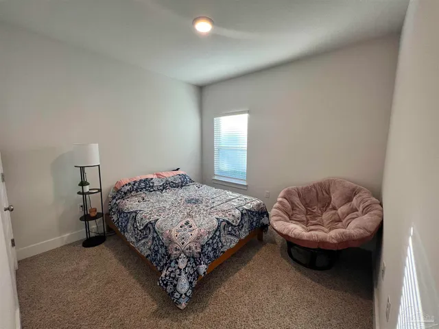 a living room with furniture and a lamp