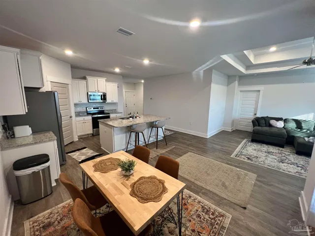 a view of a dining room with furniture window and wooden floor