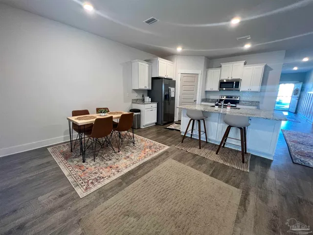 a kitchen with sink refrigerator and microwave