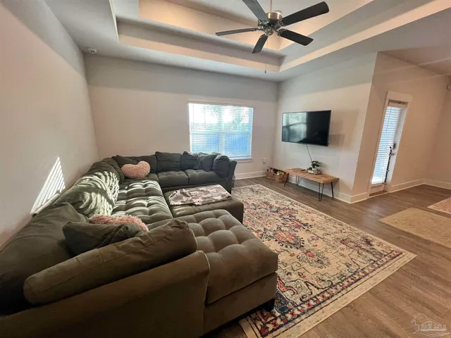 a living room with furniture and a flat screen tv