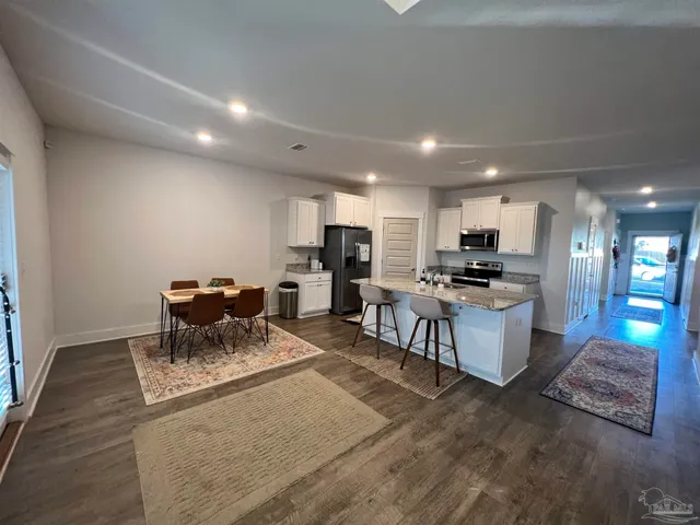 a living room with furniture a ceiling fan and a rug