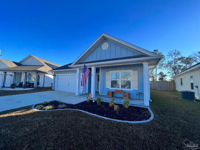 a front view of a house with a yard outdoor seating and outdoor space