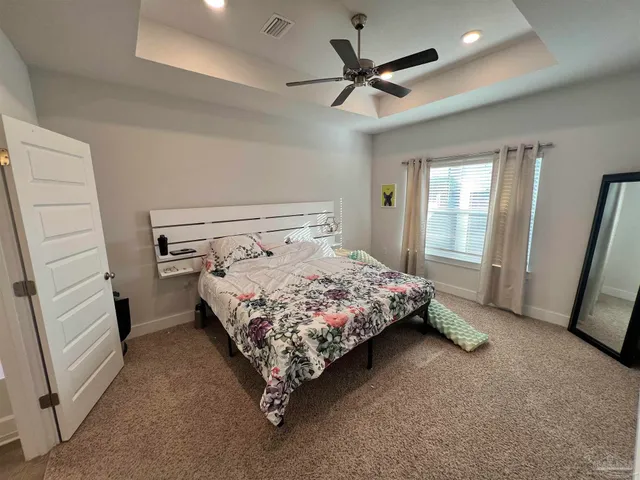 a bedroom with a bed a window and dresser