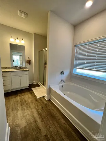 a bathroom with a granite countertop sink mirror and shower