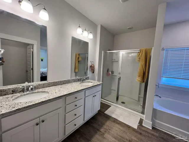 a bathroom with a granite countertop sink shower and a mirror