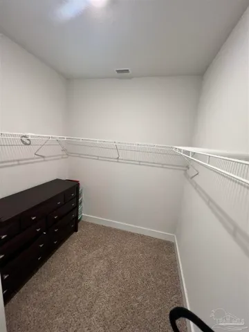 a white toilet sitting next to a shower