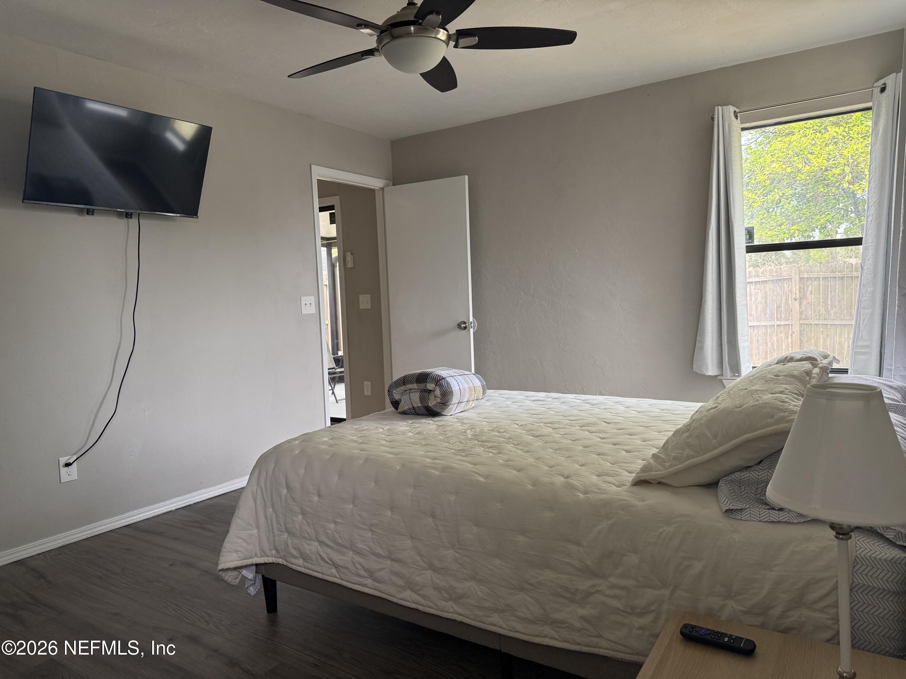 2360 Bitternut Way Jacksonville, FL 32246 - Photo 12 of 25 a bedroom with a bed and a flat screen tv