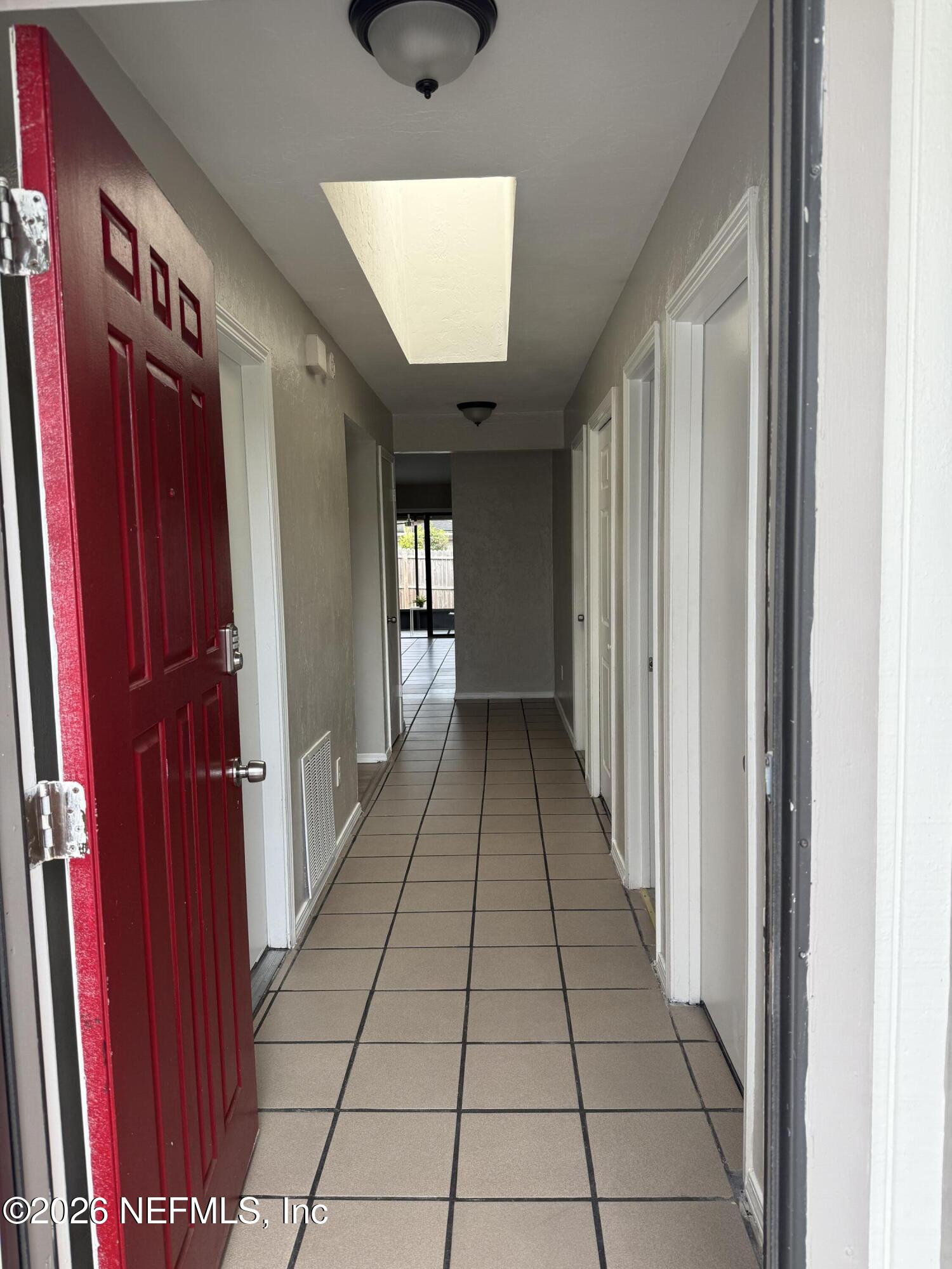 2360 Bitternut Way Jacksonville, FL 32246 - Photo 4 of 25 a view of a hallway with wooden floor and staircase