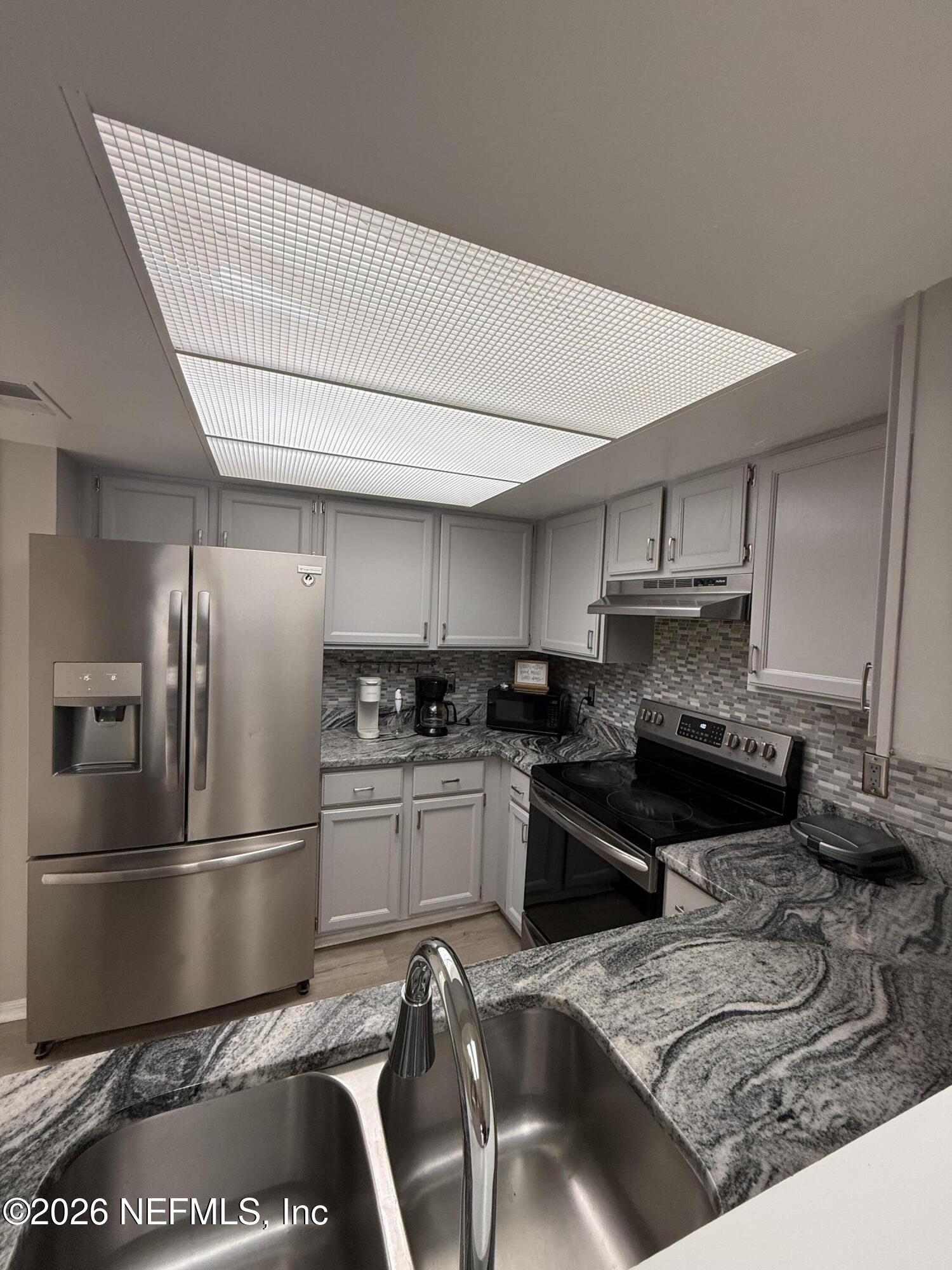 2360 Bitternut Way Jacksonville, FL 32246 - Photo 8 of 25 a kitchen with stainless steel appliances granite countertop a stove a refrigerator a sink a stove and island