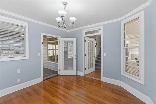 a view of a livingroom with wooden floor and a ceiling fan