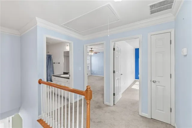 an empty room with windows and chandelier fan