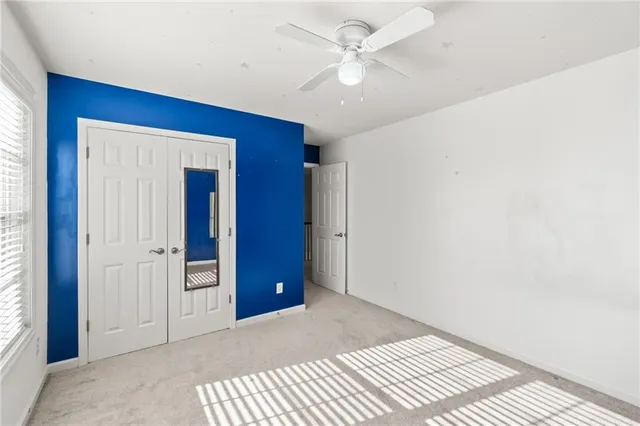 a bedroom with chandelier walk in closet and wooden floor