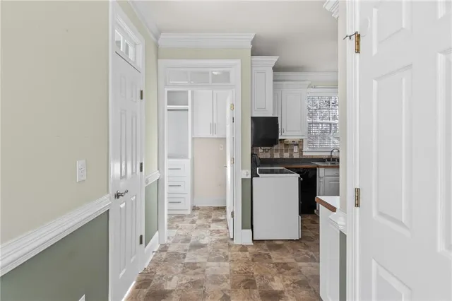 a kitchen with stainless steel appliances granite countertop a sink a stove and refrigerator