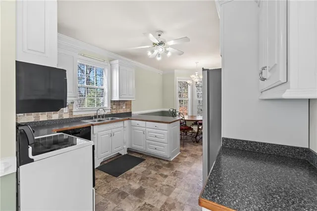 a kitchen with refrigerator and cabinets
