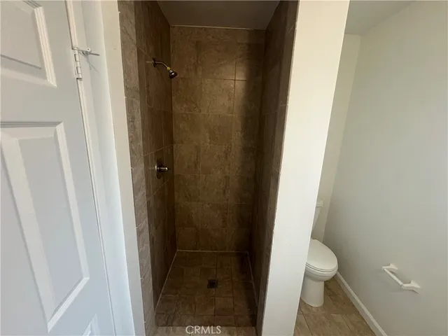 a view of a house with a backyard and trees