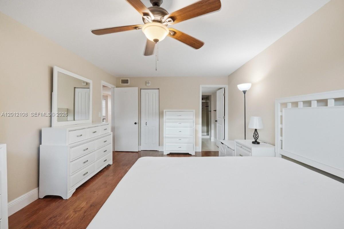 8826 West McNab Road, Unit 304 Tamarac, FL 33321 - Photo 13 of 22 a spacious bedroom with a bed and a chandelier