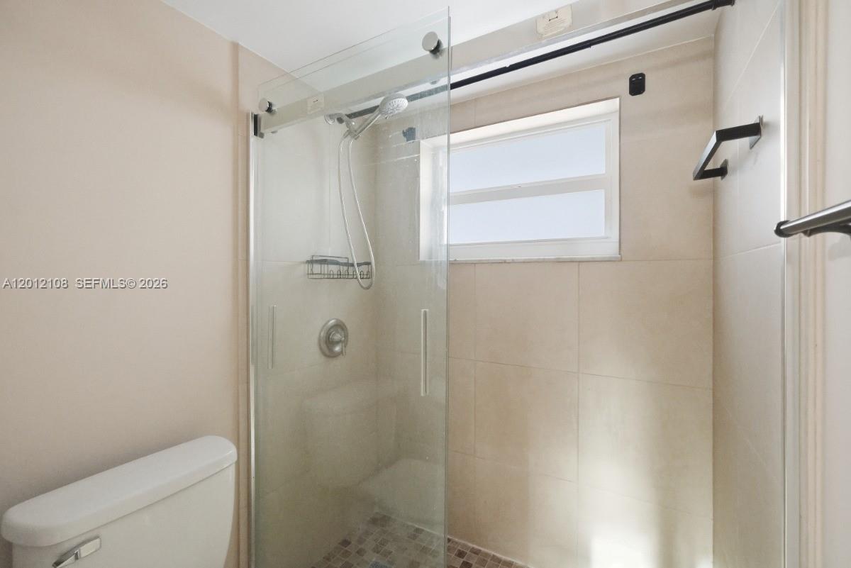 8826 West McNab Road, Unit 304 Tamarac, FL 33321 - Photo 18 of 22 a bathroom with a shower and a toilet