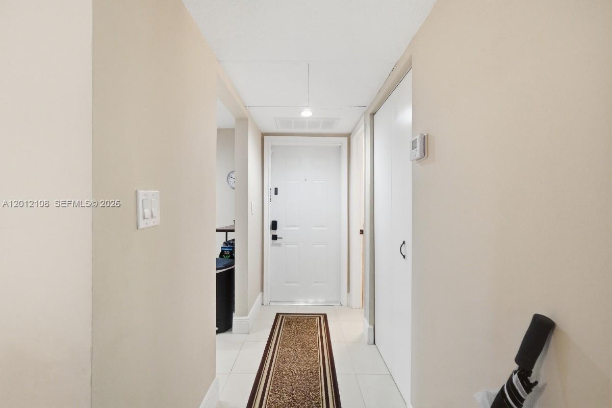 8826 West McNab Road, Unit 304 Tamarac, FL 33321 - Photo 2 of 22 a view of a hallway with wooden floor and staircase