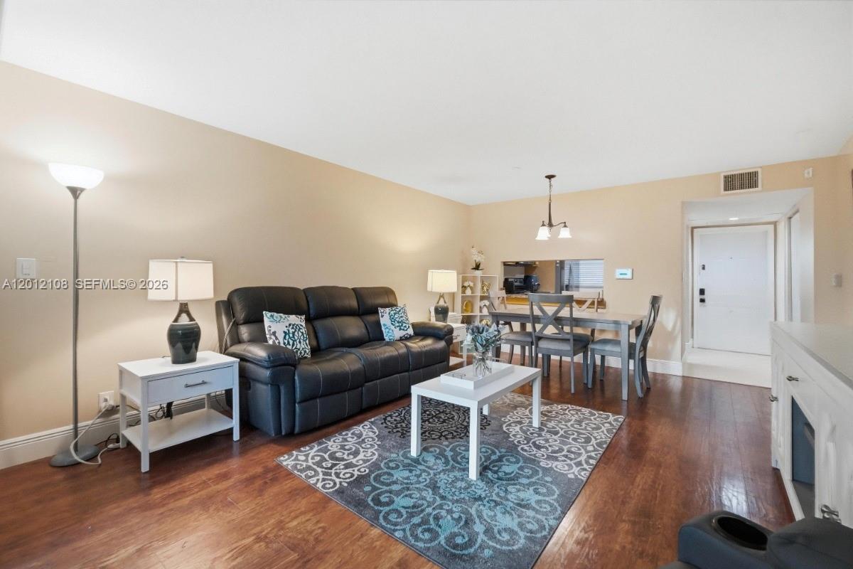8826 West McNab Road, Unit 304 Tamarac, FL 33321 - Photo 10 of 22 a living room with furniture a dining table and a rug