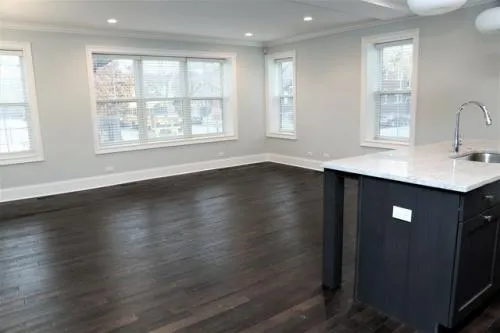 a view of a kitchen with wooden floor and windows