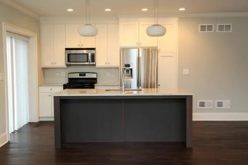 a kitchen with stainless steel appliances a refrigerator sink and microwave