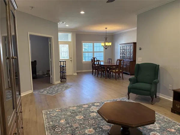 a living room with furniture and a dining table
