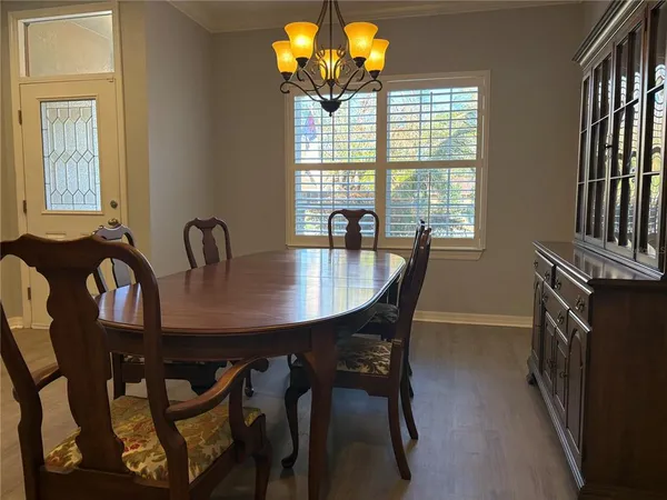 a dining room with furniture and window