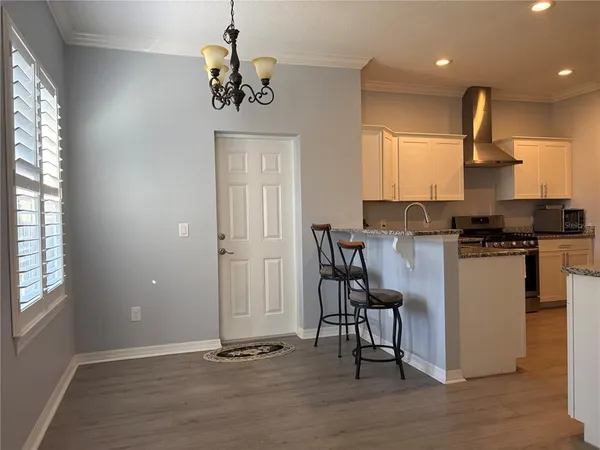 a kitchen with granite countertop a stove a sink and a refrigerator