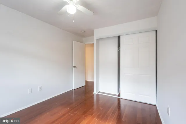 an empty room with wooden floor and a window