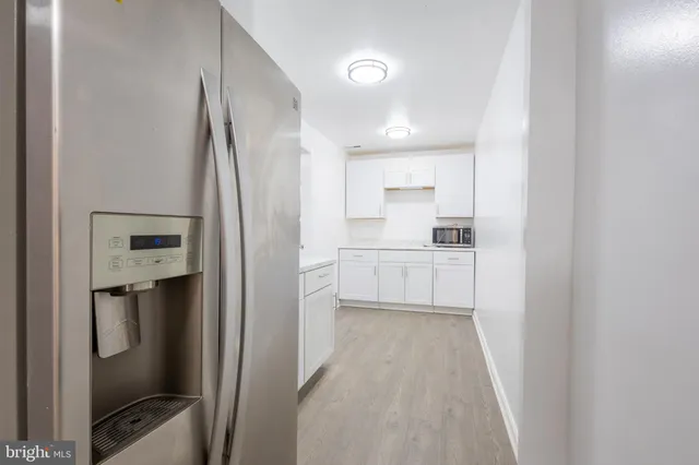 a kitchen with stainless steel appliances a refrigerator sink and cabinets