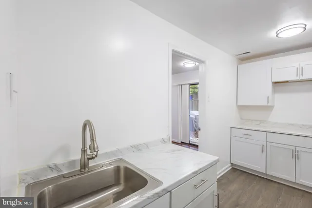 a kitchen with a sink and cabinets