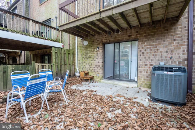 a backyard of a house with barbeque oven table and chairs
