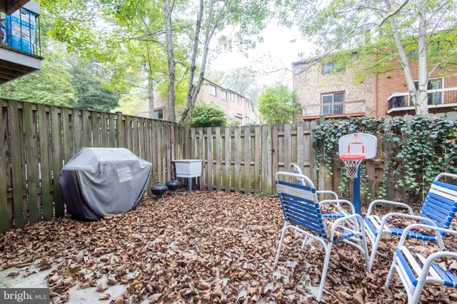 a view of a chairs and table in backyard of house