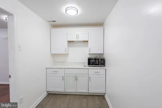 a kitchen with white cabinets