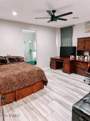 a bedroom with a bed and wooden floor