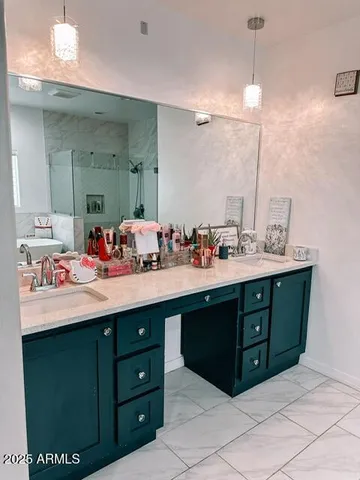 a bathroom with a sink vanity and mirror