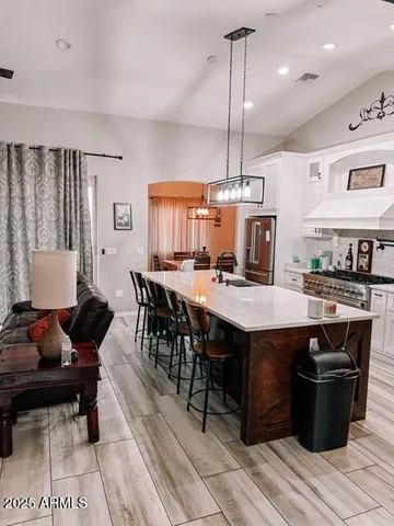 a room with table chairs and wooden floor