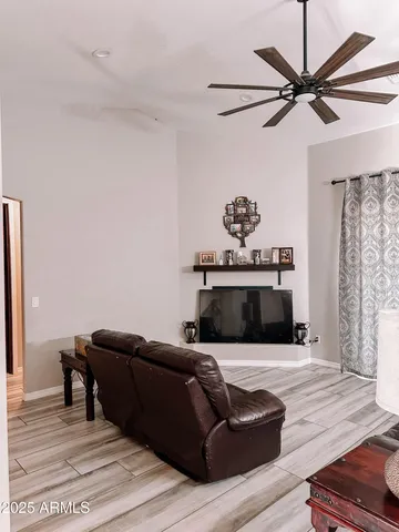 a living room with furniture and a wooden floor