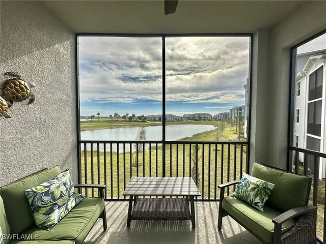 a balcony with furniture and a window