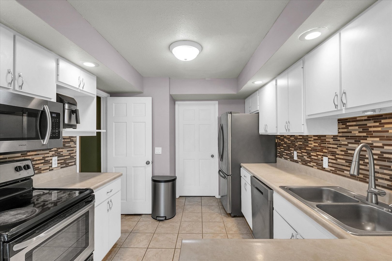 1727 Devonshire Drive Champaign, IL 61821 - Photo 15 of 48 a kitchen with stainless steel appliances granite countertop a sink stove and refrigerator