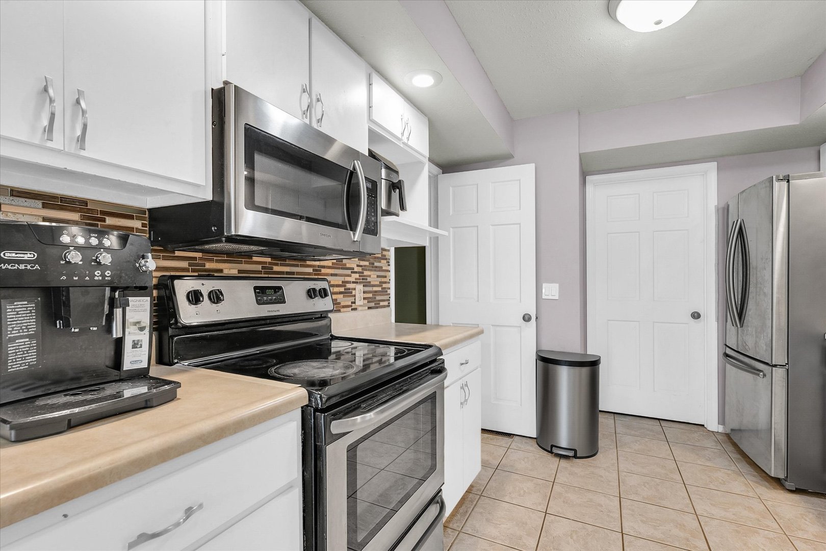 1727 Devonshire Drive Champaign, IL 61821 - Photo 16 of 48 a kitchen with a stove and a microwave