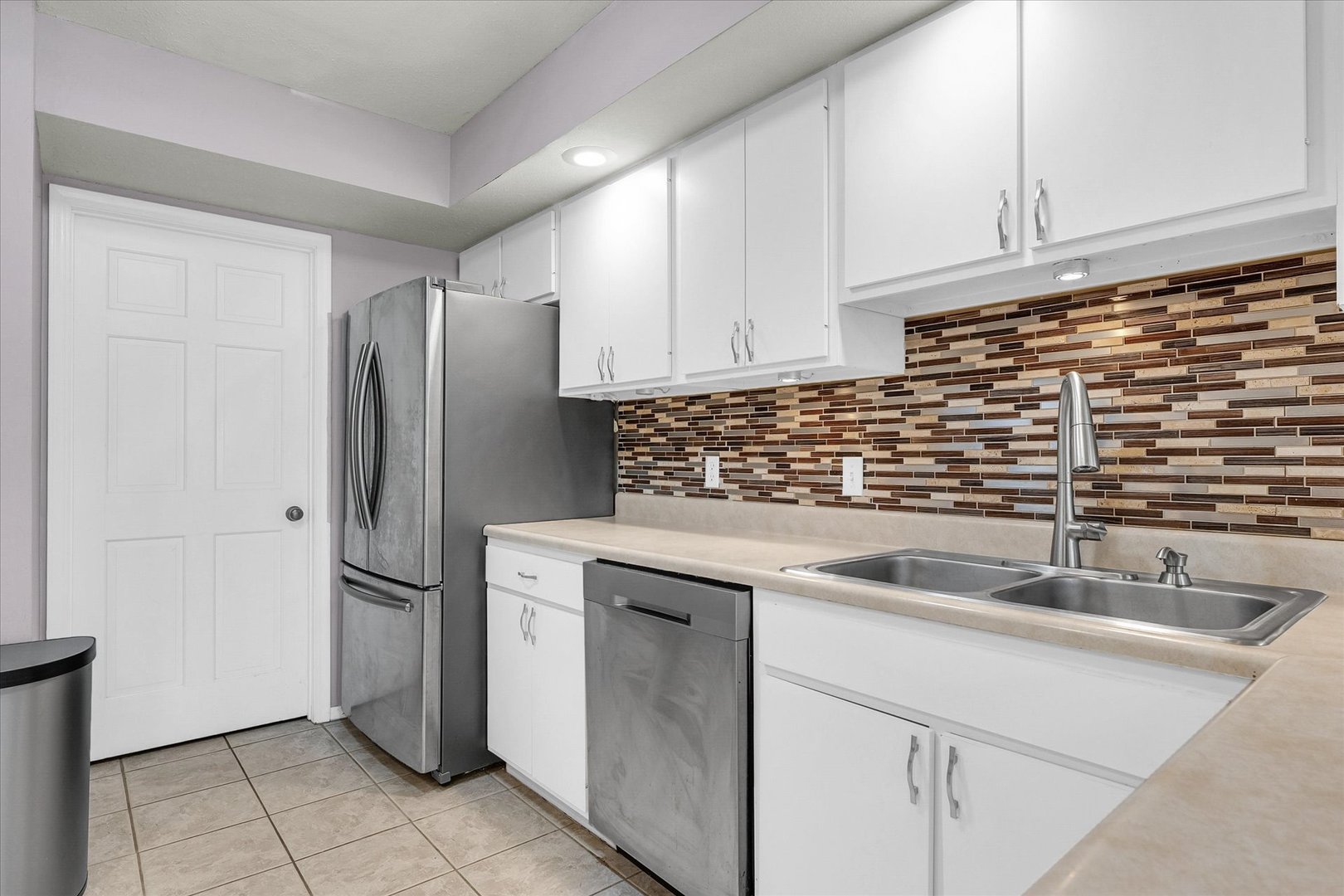 1727 Devonshire Drive Champaign, IL 61821 - Photo 17 of 48 a kitchen with stainless steel appliances granite countertop a sink and a refrigerator
