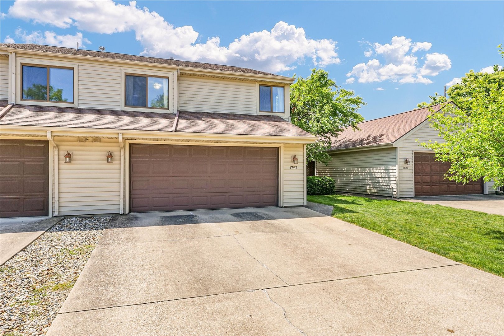 1727 Devonshire Drive Champaign, IL 61821 - Photo 2 of 48 a front view of a house with garden