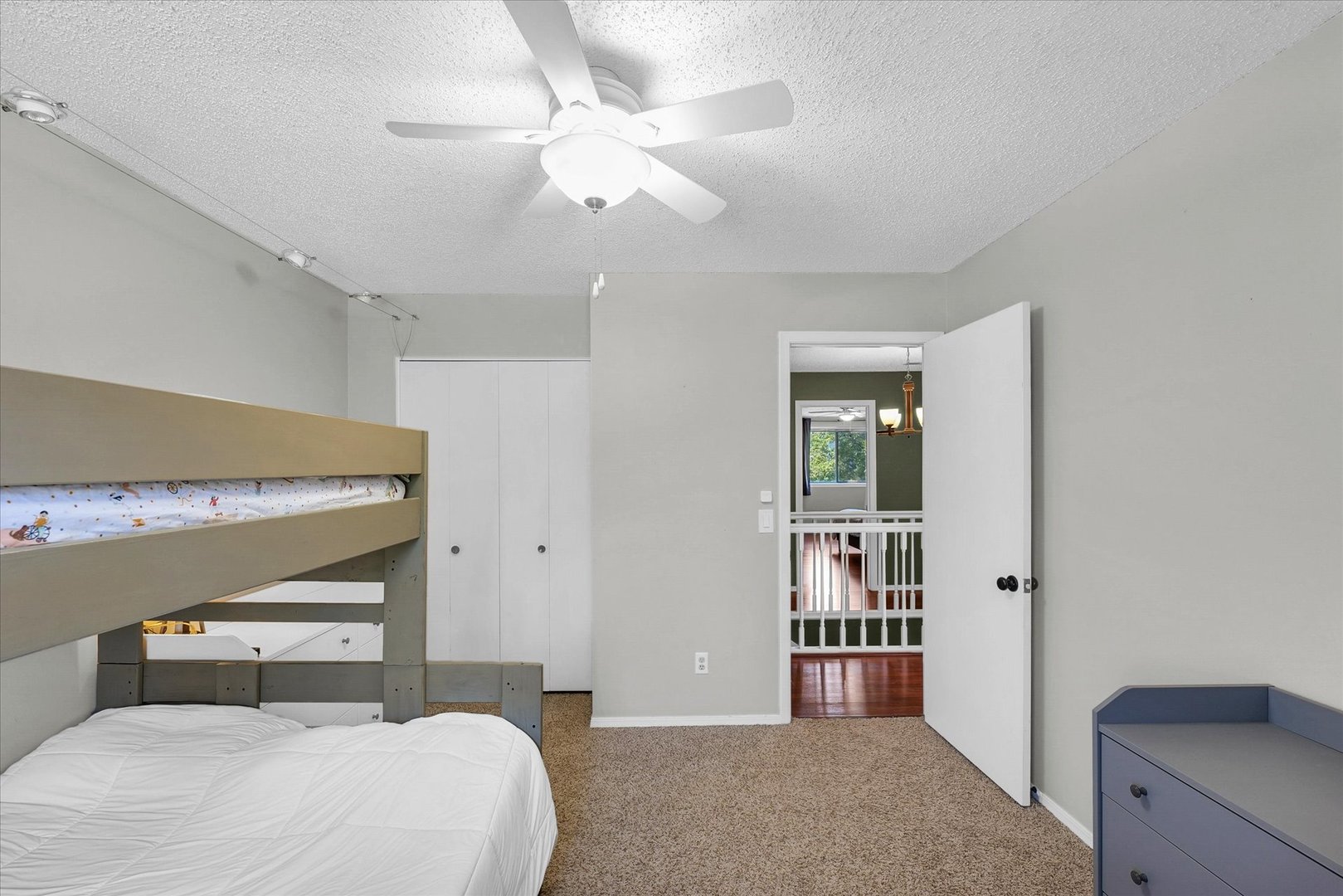 1727 Devonshire Drive Champaign, IL 61821 - Photo 39 of 48 a bedroom with a large bed and a chandelier