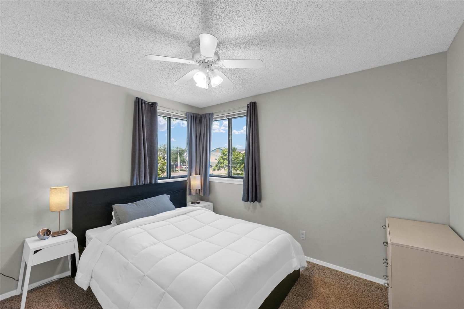 1727 Devonshire Drive Champaign, IL 61821 - Photo 40 of 48 a bedroom with a large bed and a chandelier