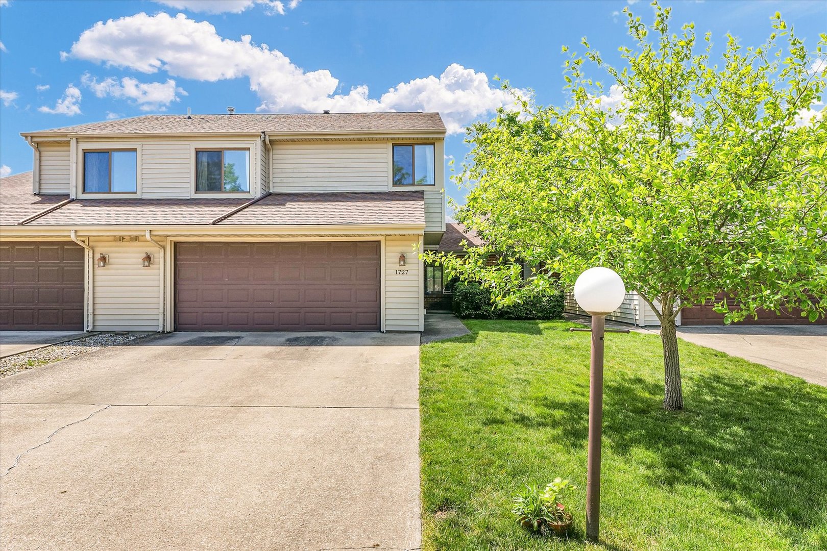 1727 Devonshire Drive Champaign, IL 61821 - Photo 4 of 48 a front view of a house with a yard and a garage