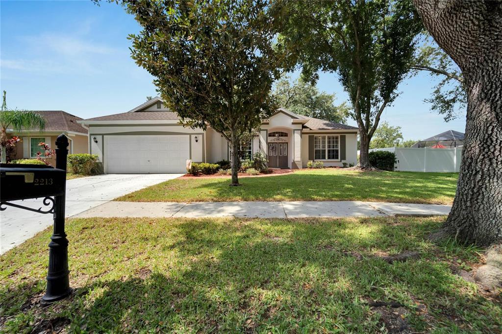 2213 Longmore Circle Valrico, FL 33596 - Photo 1 of 1 a front view of house with yard and trees around