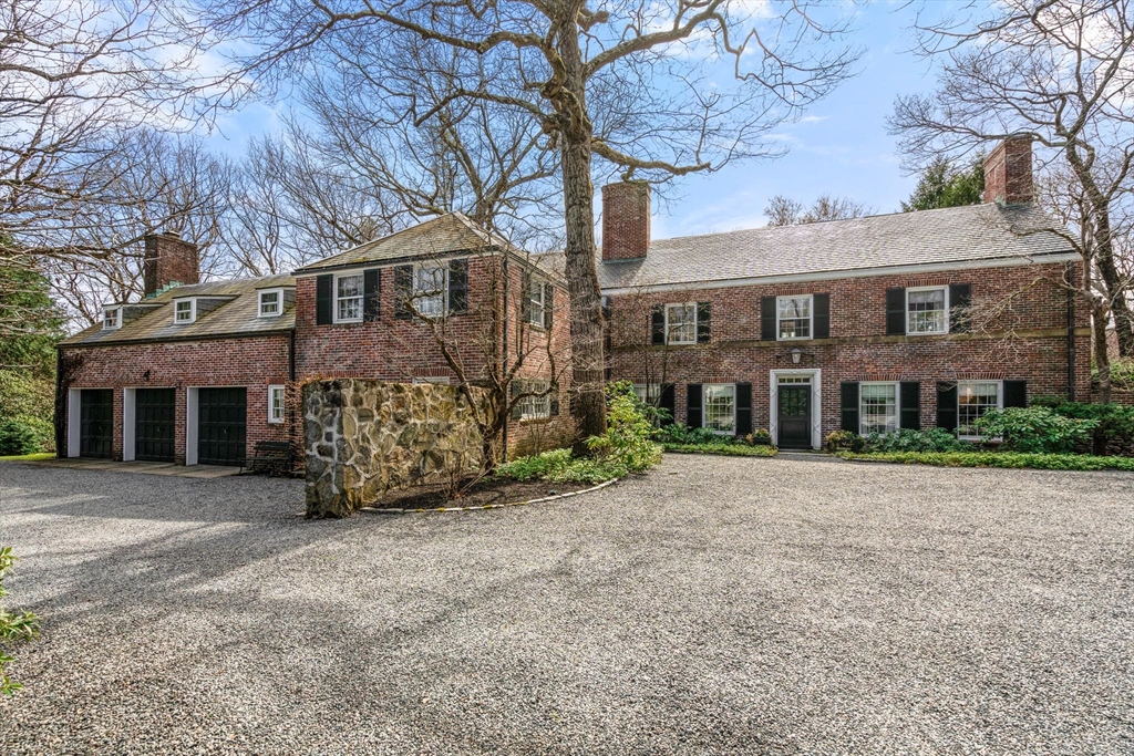 27 Laurel Road Chestnut Hill, MA 02467 - Photo 1 of 20 a view of a brick house with a large windows and a large tree